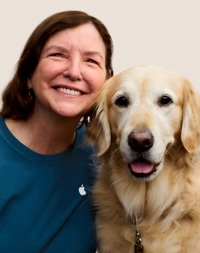 Portrait of a smiling Apple Retail team member with a guide dog.