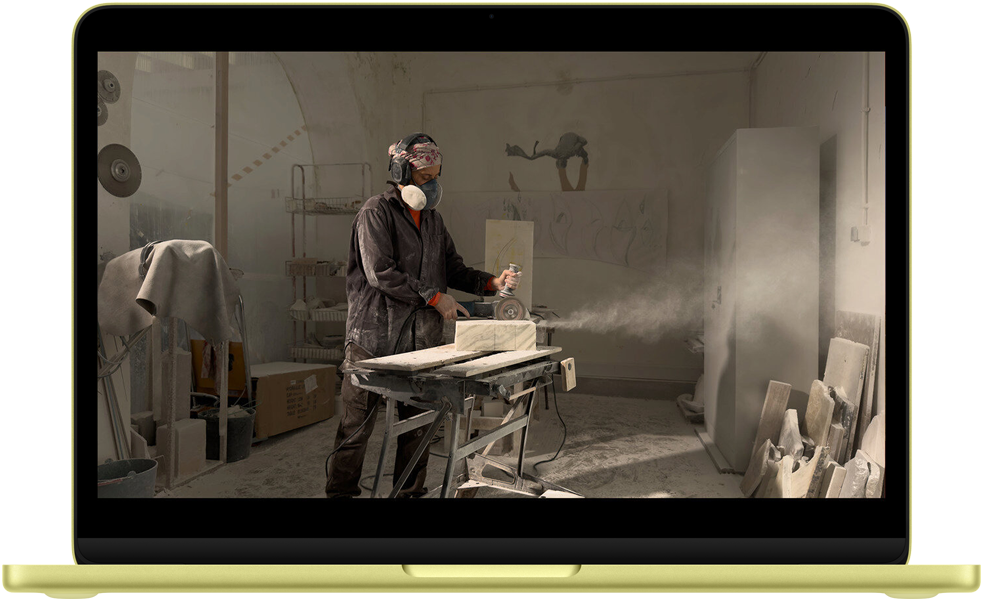 MacBook Neo, puslu sarı renk, ekranda QuickTime videosu yer alıyor