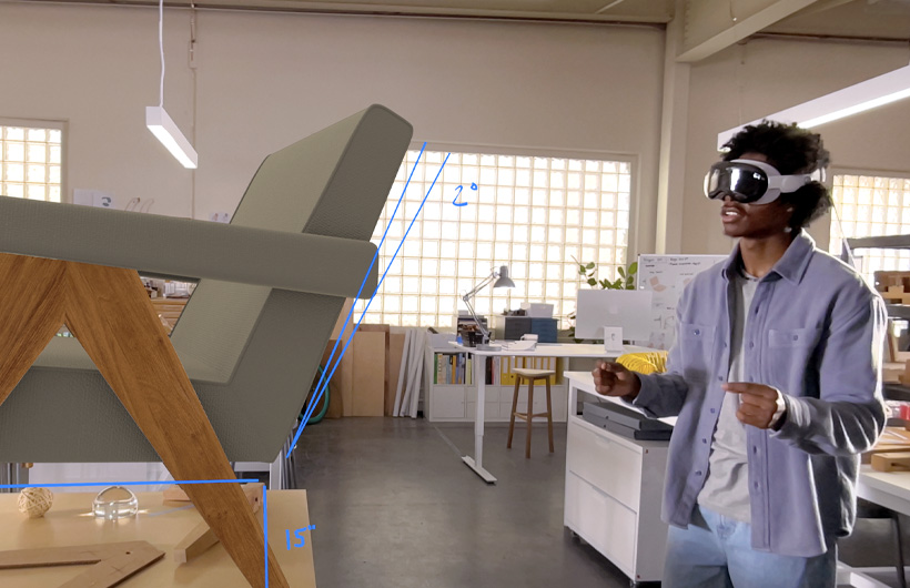 Person wearing Apple Vision Pro uses hand movements to measure a 3D projection of a chair