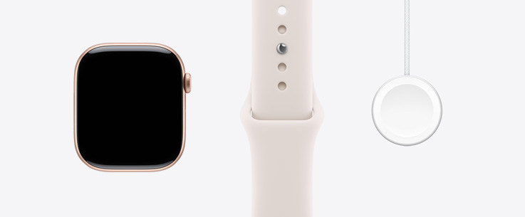 Parte da frente do Apple Watch Series 11 com caixa de alumínio ouro rosa, tela de ponta a ponta e pulseira esportiva blush-clara. Ao lado, o cabo magnético para recarga rápida com conector USB-C para Apple Watch