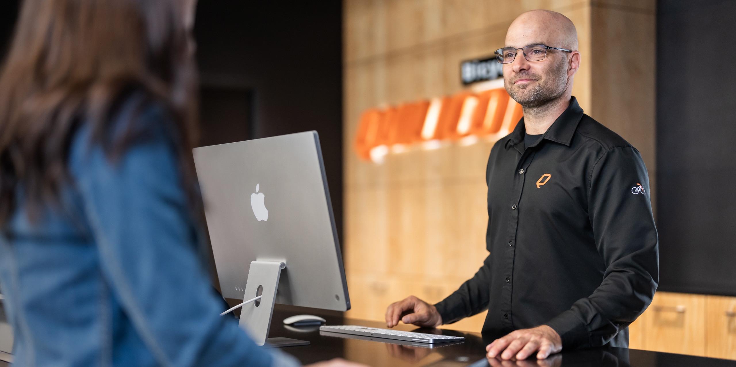 A Bicycles Quilicot employee completes a customer purchase on iMac.
