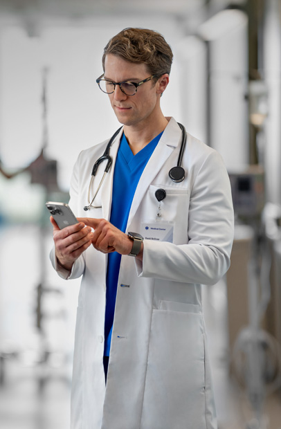 Håndleddet til en behandler med en Apple Watch som viser en varsling om medisin fra Epic-appen.